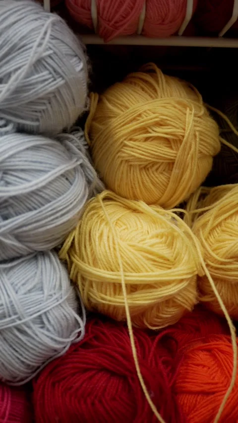 Vertical format. Colorful knitting yarn. Yarn store display rack of colorful pro Video stock 271067314