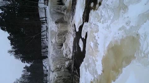 Vertical format: Dolly shot at Keila waterfall, Estonia in winter ice Stock Footage 328275011