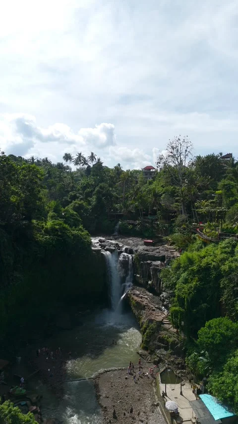 Vertical-format drone view showcasing the Tegenungan Waterfall in lush Balinese Stock Footage 323071515