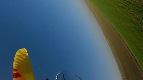 Vertical format: FPV drone buzzes motor paraglider in agri countryside Stock Footage 262306700