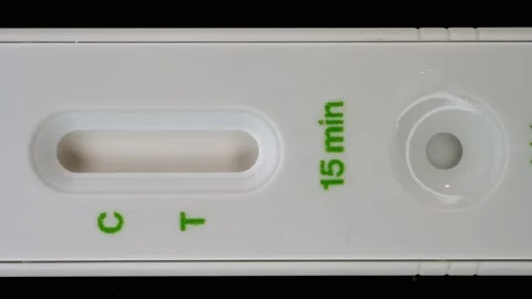 Vertical format of a positive COVID test as a time lapse.  Stock Footage 221354599