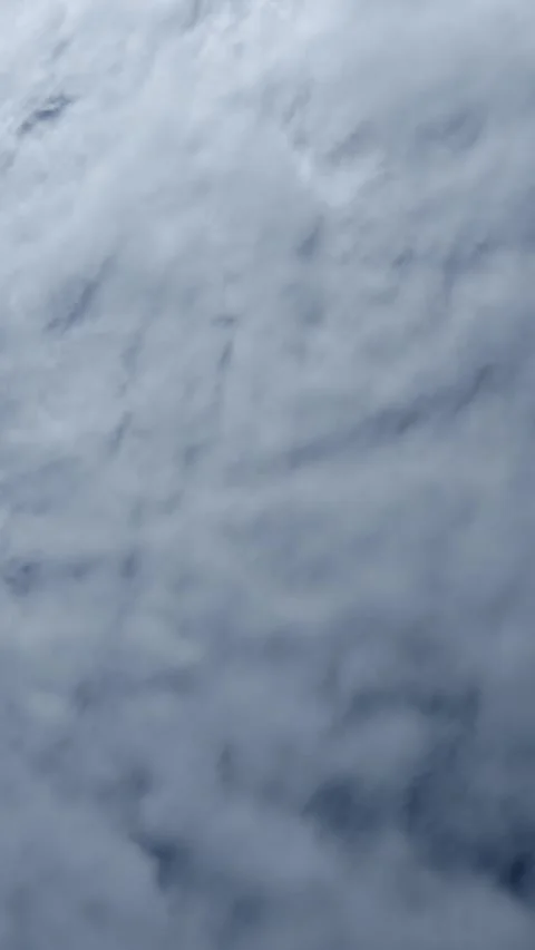 Vertical format timelapse of white clouds moving across a dark blue sky Stock Footage 331222745