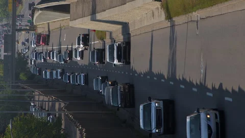 Vertical format vehicle traffic driving on roadway through modern city Stock Footage 317145199