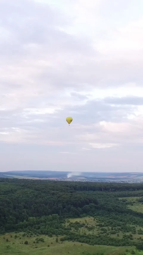 Vertical Format Video of In this aerial video of hot air balloons. Against the Stock Footage 309562256