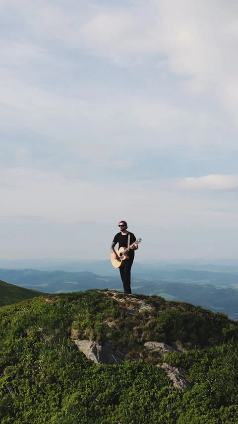 Vertical Format Video of Aerial view of Musician plays an acoustic guitar. Man Stock Footage 304816188