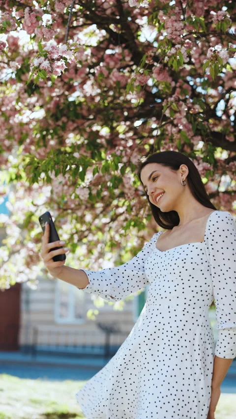 Vertical Format Video of beautiful joyful young Caucasian woman in white dress Stock Footage 304669560