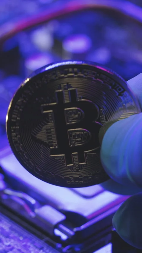 Vertical Format Video of Businessman hands hold gold Bitcoin on motherboard Stock Footage 304330009