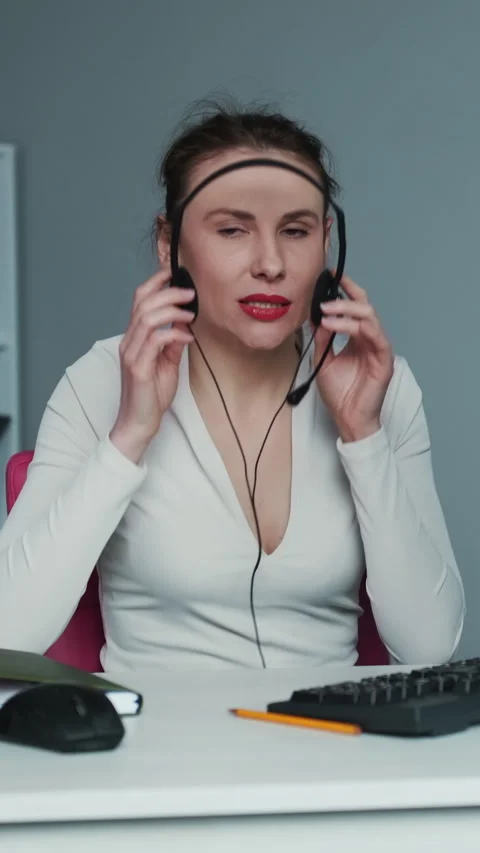 Vertical Format Video of Call center operator is tired of talking to people Stock Footage 302720640