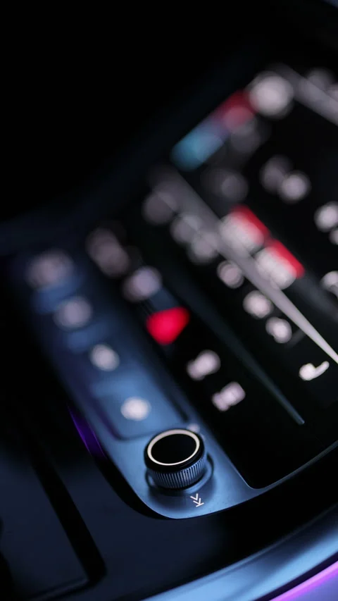 Vertical format video of Car dashboard volume knob. Drivers hand adjusts volume Stock Footage 335948059