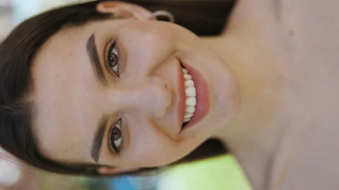 Vertical format video Close up portrait Smiling attractive young adult woman Stock Footage 194660034