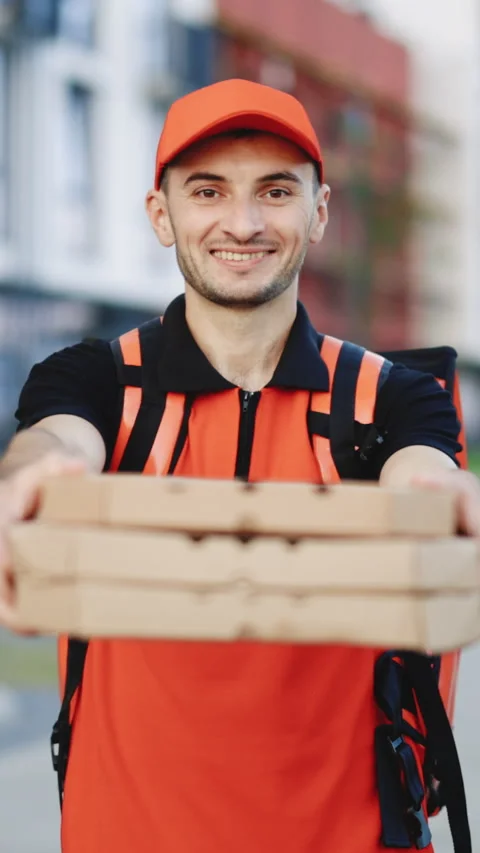 Vertical Format Video of delivery man with hot pizza boxes waiting for customer Stock Footage 304176149