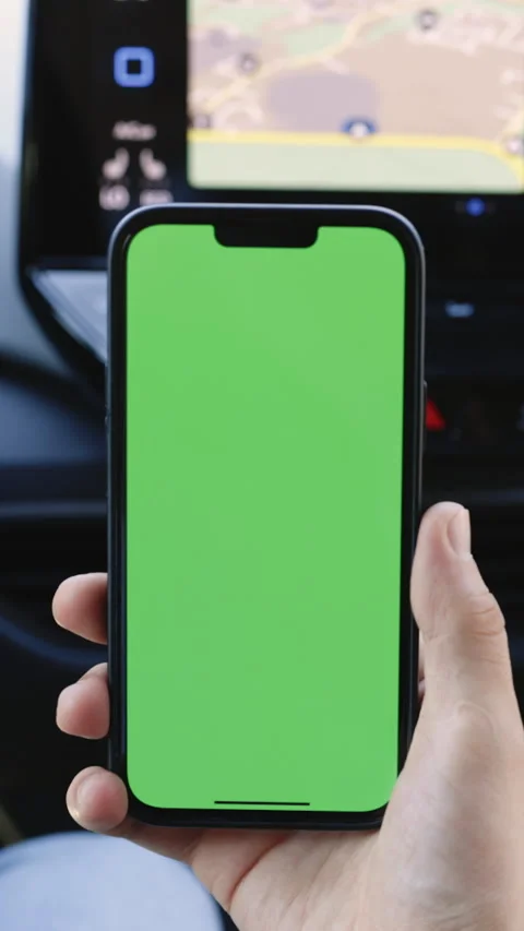 Vertical Format Video of driver in car uses a smartphone with a green screen Stock Footage 306611168