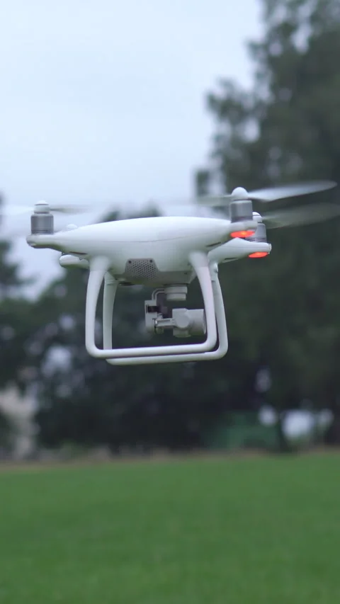 Vertical Format Video of a drone landing. Drone takes off into the sky. Drone Stock Footage 309233929
