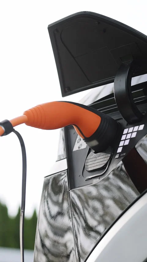 Vertical Format Video of Electric vehicle charging port plugging in EV modern Stock Footage 306737700
