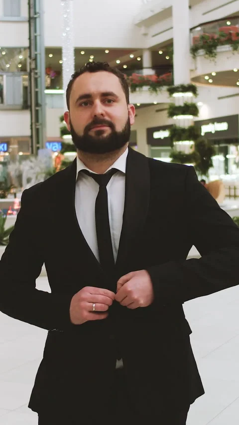 Vertical Format Video of elegant businessman in suit, correcting his jacket Stock Footage 309649741