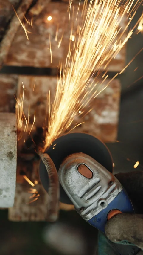Vertical Format Video of Foreman in protective gloves using grinder cutting Stock Footage 306057352