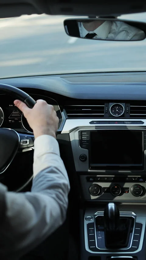 Vertical Format Video of Handsome elegant man drives car. Professional male Stock Footage 304877048