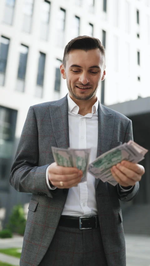 Vertical Format Video of Handsome Rich Man Wearing Stylish Suit Counting Money Stock Footage 302798906