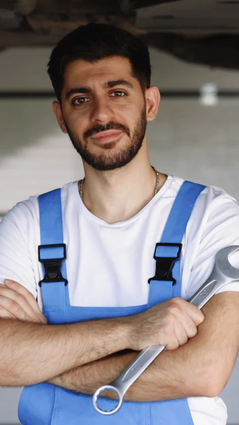 Vertical Format Video of Portrait of bearded mechanic repairing in uniform Stock Footage 305184393