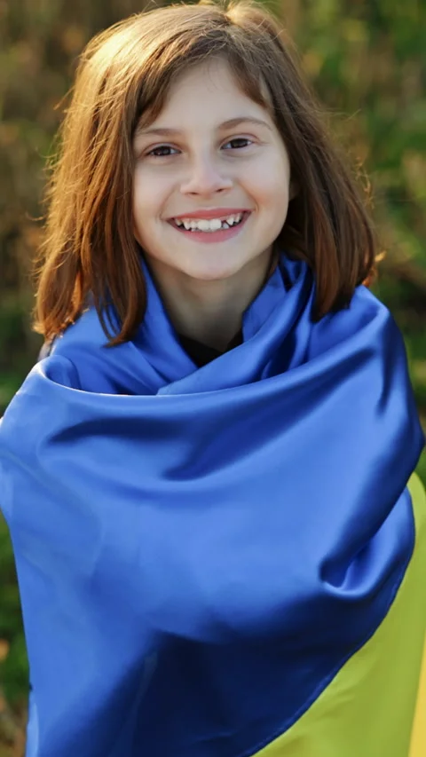 Vertical Format Video of Portrait of Child with Ukrainian flag in field. Little Stock Footage 305442735