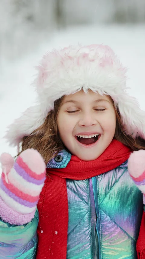 Vertical Format Video of Portrait of cute little girl in winter. Happy child in Stock Footage 304910782
