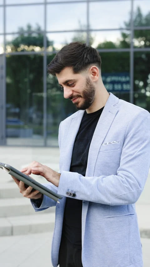 Vertical Format Video of Portrait mode of young man engaged in business using Stock Footage 305862205