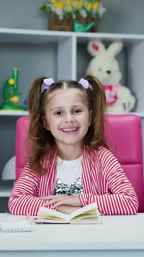 Vertical Format Video of Portrait of preschool girl looking at the camera and Stock Footage 303271609
