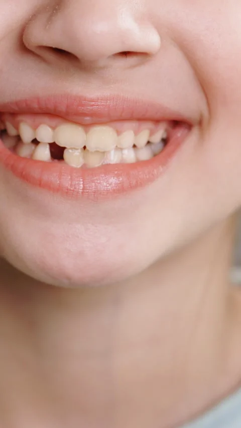 Vertical Format Video of portrait of young little girl smiling with a toothless Stock Footage 305748694