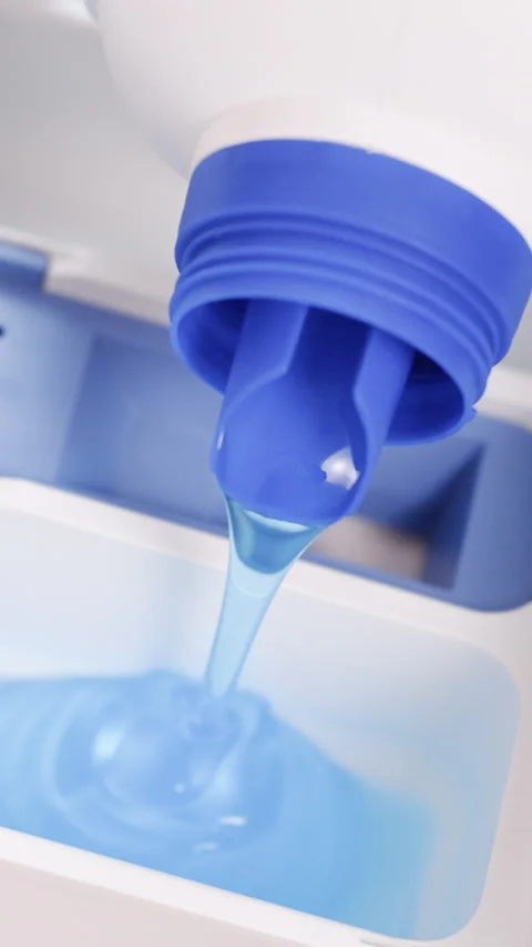 Vertical Format Video of Pour some laundry detergent on the clothes and put it Stock Footage 306364670