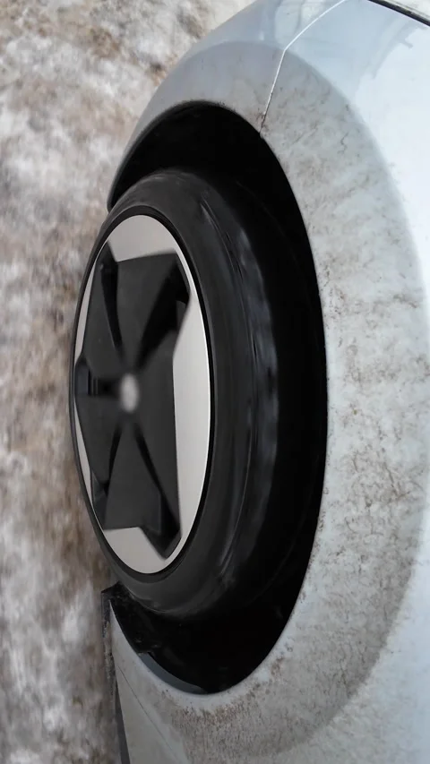 Vertical Format Video of POV Driving car with winter tire wheel on road. Detail Stock Footage 306693547