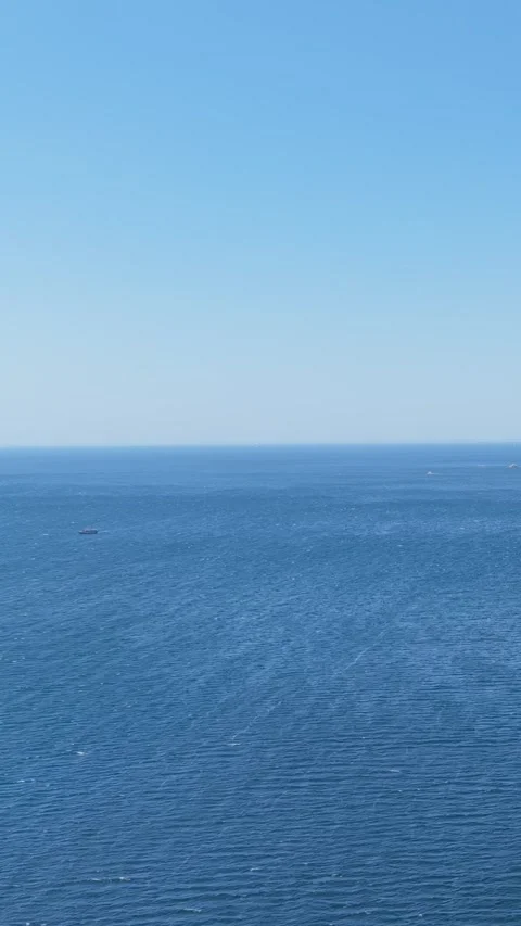 Vertical format video showing a wide expanse of the blue Atlantic Ocean under a Stock Footage 346650210