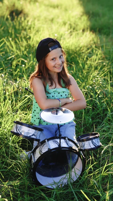 Vertical Format Video of smiling drummer girl crossed arms smiling at camera Stock Footage 306234476
