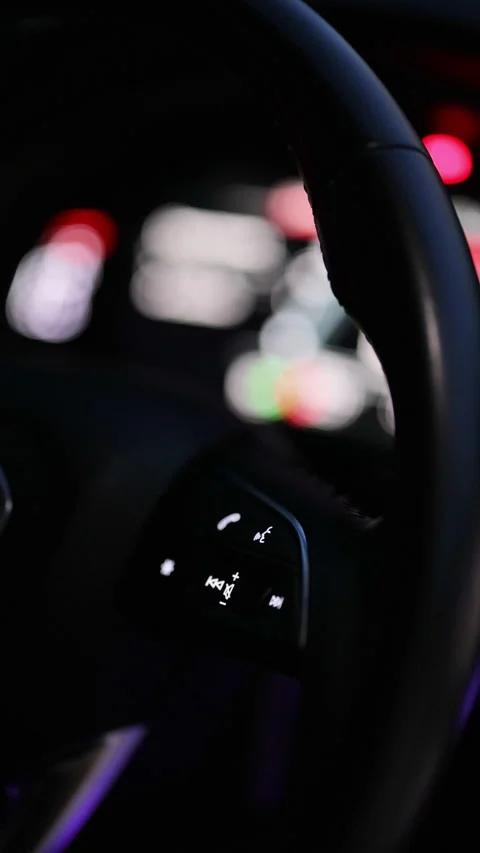 Vertical format video of steering wheel of car control music. The hand turns the Stock Footage 335958885