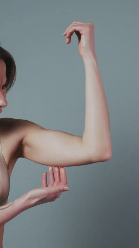 Vertical Format Video of Weight Loss Concept. Woman Pinching Upper Arm Fat 動画素材 302720372