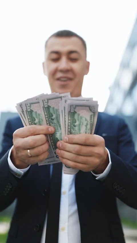 Vertical Format Video of Young Handsome Rich Man Wearing Stylish Suit Counting Stock Footage 302803174