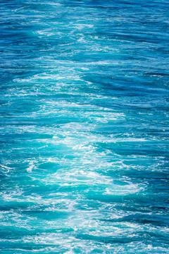 Vertical format of the wake behind cruise ship off Alaska Blue water of th... Stock Photos