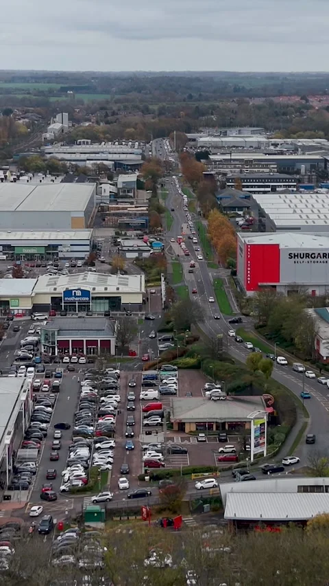 Vertical forward drone flight over Harlow's Temple Mills Retail Park, showing Stock Footage 321437486