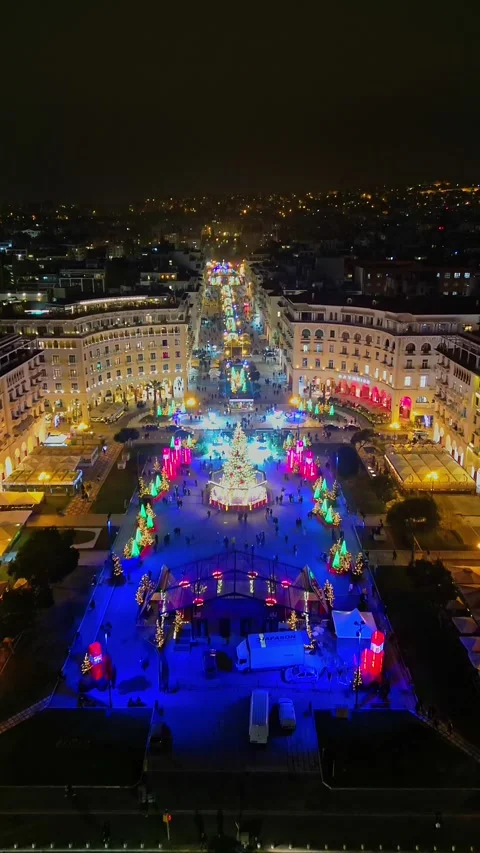 Vertical forward drone flight over illuminated Christmas square and street Stock-Footage 345934644