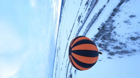 Vertical FPV Dramatic Drone Shot, Flying Above Hot Air Balloon and Snowy Stock Footage 195105697