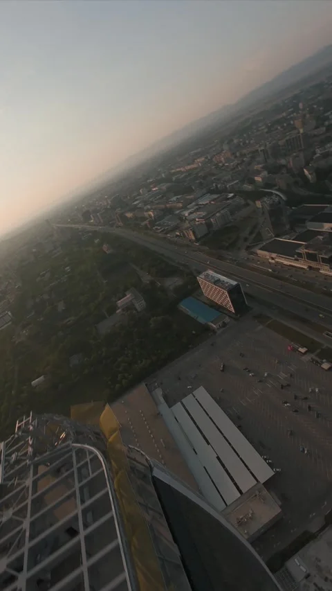 Vertical FPV drone dive between modern skyscrapers at sunset in Sofia, Bulgaria. Stock Footage 340814552