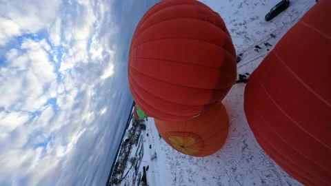 Vertical FPV Drone Shot of Hot Air Balloons Parachutes in Snow on Cold Stock Footage 194554851