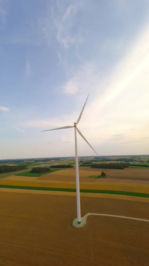 Vertical FPV Drone Shot Of Wind Turbine In Golden Hour Wheat Field Stock Footage 341696150