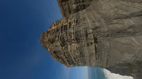 Vertical FPV: Flight up rugged rock strata sea stack, Portugal coast Video stock 271724980