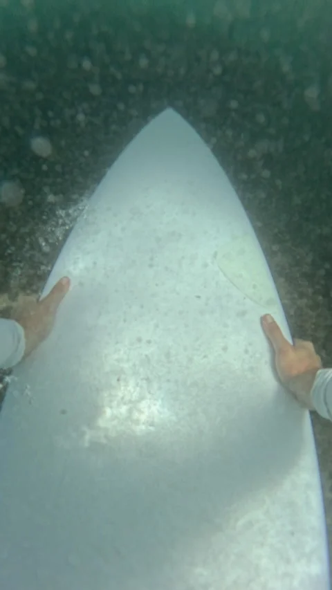 VERTICAL, FPV, SLOW MOTION: Surfer makes a duck dive beneath a breaking wave Stock Footage 339086142