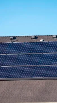 Vertical frame Array of solar panels on a house roof in close up 写真素材