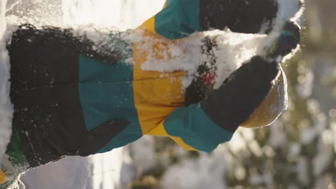 Vertical frame A cheerful boy revels in the magic of winter with snowflakes Stock Footage 295424530