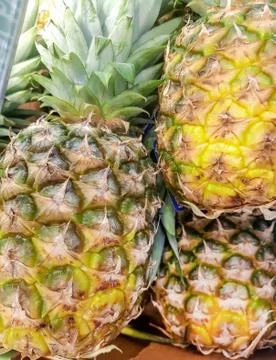 Vertical frame, close-up of pineapples, top view, lots of pineapple fruit bac Stock Photos