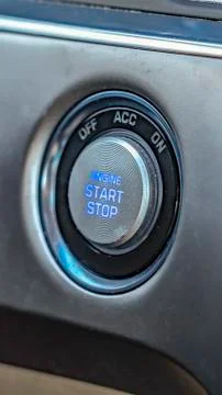Vertical frame Close up view of an engine push start and stop button inside a Foto stock