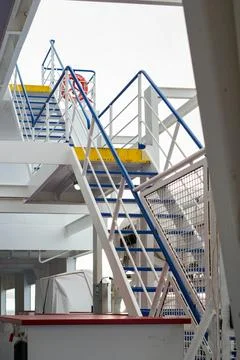 Vertical Frame of a Complex Blue and White Industrial Staircase Structure in a s 스톡 사진