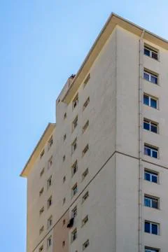 Vertical frame of concrete structured mass housing clear yellow colored facad Stock Photos